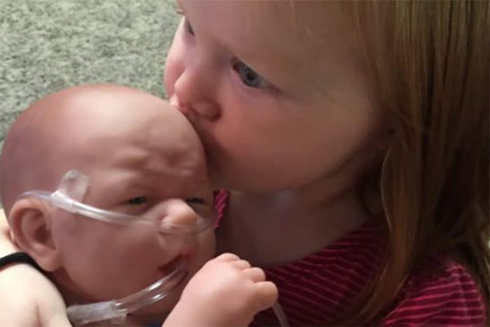 Nora Dolan with her 'baby Henry' while waiting on the real Henry to recover from a heart transplant. Photo: Facebook