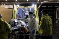 Ambulance crew work as a patient arrives at the CHR CItadelle hospital in Liege, Belgium, Thursday, Oct. 29, 2020. Belgium has announced restrictive measures across the country in an effort to curb the fast-rising tide of COVID-19, coronavirus cases. (AP Photo/Valentin Bianchi)