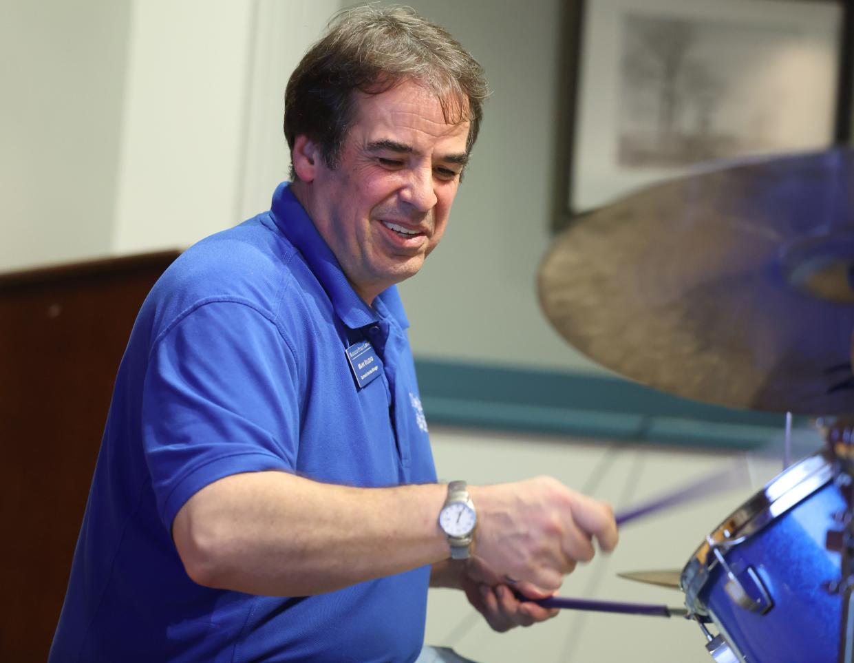Mark Villono, outreach services manager at Massillon Public Library, sits in Monday, Dec. 4, 2023, on drums for Jam Night at the library.