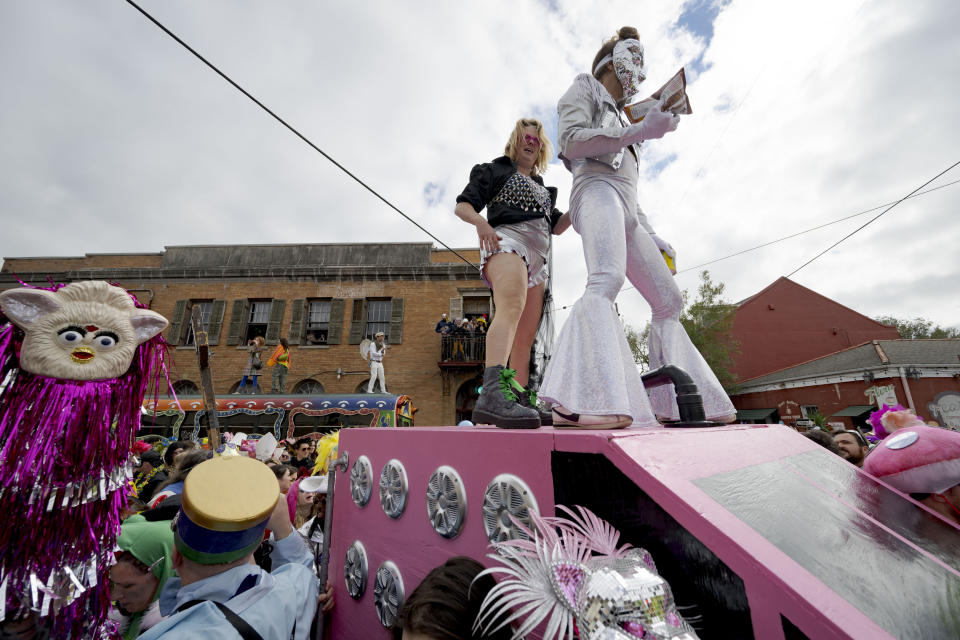 People dance in costumes during the Society of Saint Anne parade through Bywater and Marigny neighborhoods on Mardi Gras Day in New Orleans, Tuesday, Feb. 13, 2024. (AP Photo/Matthew Hinton)