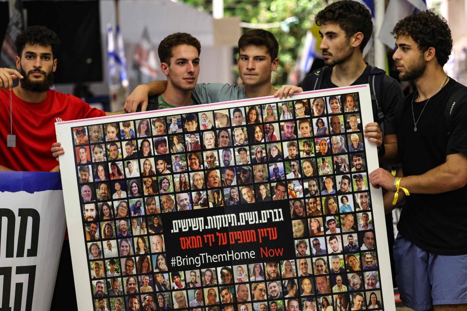 Relatives, friends and supporters of Israeli hostages held in Gaza since the October 7 attack by Hamas militants in southern Israel, hold placards and images of those taken during a protest for their release in Tel Aviv on November 22, 2023.