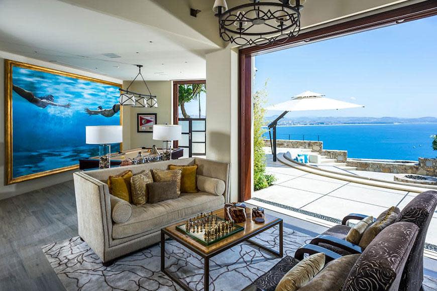 This property has multiple living rooms that all overlook the crystal-blue sea. This one has a pool table and chess board, perfect for that chilled night in.