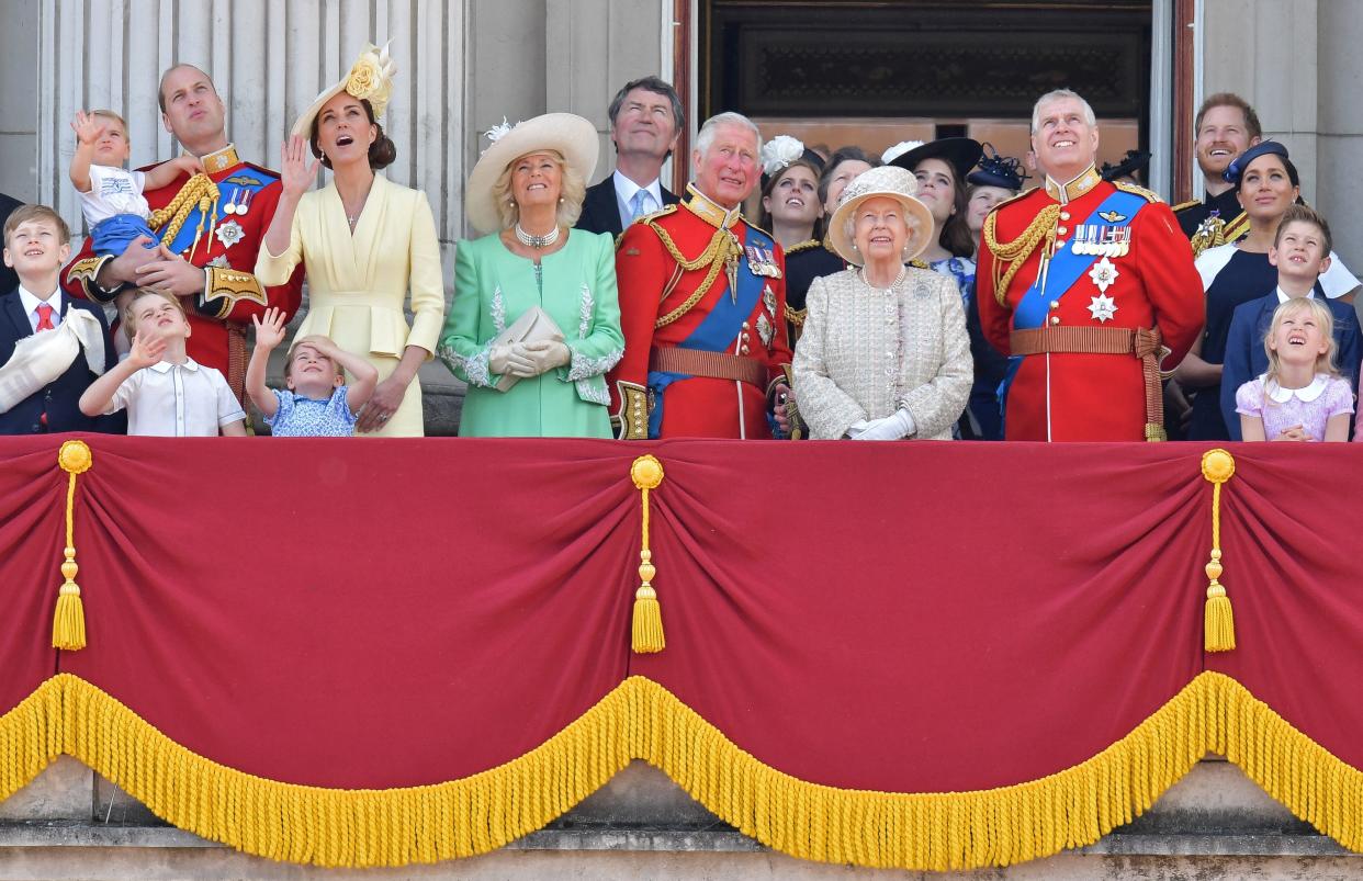 TOPSHOT - (L-R) Britain's Prince William, Duke of Cambridge holding Prince Louis, Prince George, Princess Charlotte, Britain's Catherine, Duchess of Cambridge, Britain's Camilla, Duchess of Cornwall, Vice Admiral Timothy Laurence, Britain's Prince Charles, Prince of Wales, Britain's Princess Beatrice of York, Britain's Princess Anne, Princess Royal,, Britain's Queen Elizabeth II, Britain's Princess Eugenie of York, Britain's Lady Louise Windsor, Britain's Prince Andrew, Duke of York,, Britain's Prince Harry, Duke of Sussex,, Britain's Meghan, Duchess of Sussex, James, Viscount Severn and Isla Phillips stand with other members of the Royal Family on the balcony of Buckingham Palace to watch a fly-past of aircraft by the Royal Air Force, in London on June 8, 2019. - The ceremony of Trooping the Colour is believed to have first been performed during the reign of King Charles II. Since 1748, the Trooping of the Colour has marked the official birthday of the British Sovereign. Over 1400 parading soldiers, almost 300 horses and 400 musicians take part in the event. (Photo by Daniel LEAL-OLIVAS / AFP)        (Photo credit should read DANIEL LEAL-OLIVAS/AFP/Getty Images)