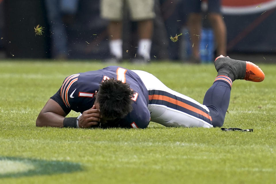 Chicago Bears quarterback Justin Fields holds his head after being tackled after have his helmet knocked off during the second half of an NFL preseason football game against the Buffalo Bills Saturday, Aug. 21, 2021, in Chicago. The Bills won 41-15. (AP Photo/Nam Y. Huh)