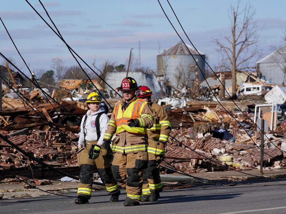 Authorities survey damage from a tornado is seen in Mayfield, Ky., on Saturday, Dec. 11, 2021 (AP)