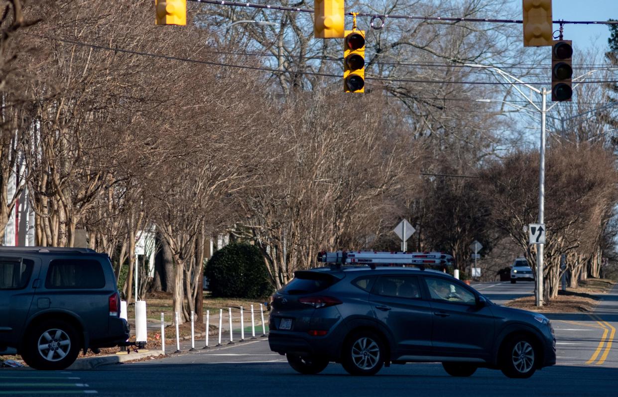 Cars navigate an intersection without stop lights due to widespread power outages in the Plaza Midwood neighborhood in Charlotte, North Carolina on December 24, 2022.