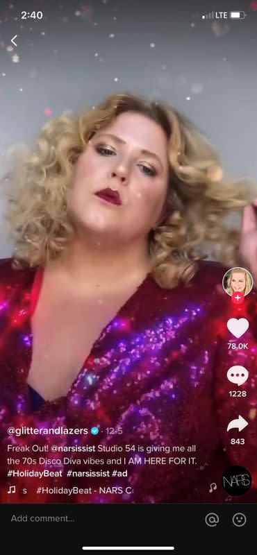 A screengrab shows a video of TikTok creator @glitterandlazers taking part in a holiday marketing campaign on TikTok for beauty brand NARS Cosmetics