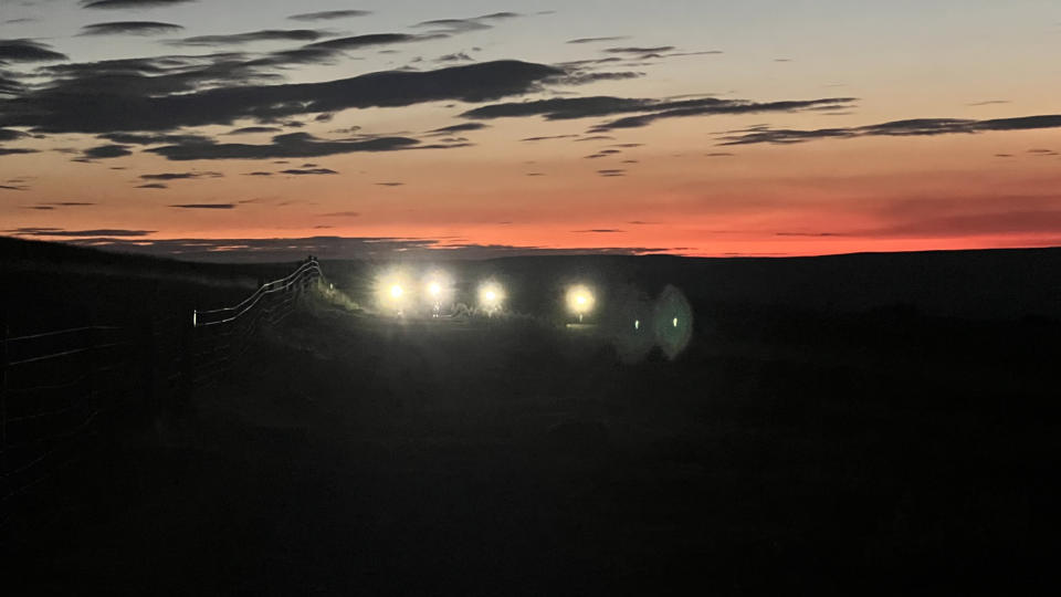 Riders with lights at dawn