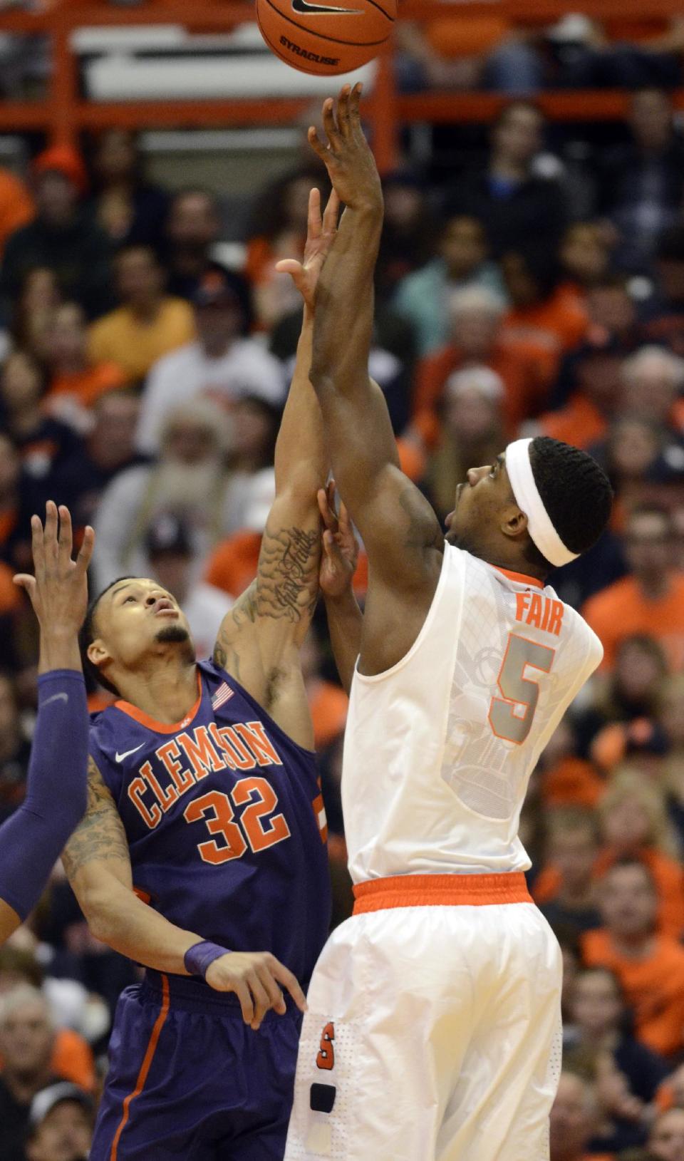 CORRECTS TO CLEMSON'S K.J. MCDANIELS NOT JARON BLOSSOMGAME - Syracuse's C.J. Fair, right, shoots over Clemson's K.J. McDaniels during the first half of an NCAA college basketball game in Syracuse, N.Y., Sunday, Feb. 9, 2014. (AP Photo/Kevin Rivoli)