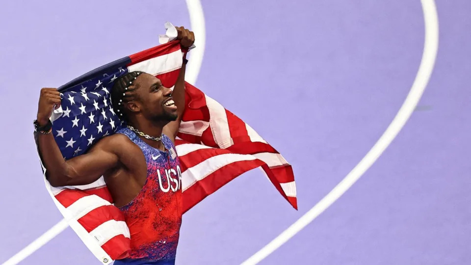 PHOTO: Noah Lyles of the U.S celebrates winning the gold medal in the men's 100m final at the 2024 Paris Olympic Games, Aug. 4, 2024. (Anne-Christine Poujoulat/AFP via Getty Images)