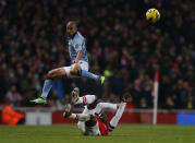 Arsenal's Bacary Sagna (bottom) challenges Manchester City's Gael Clichy during their English Premier League soccer match at the Emirates Stadium in London January 13, 2013. REUTERS/Eddie Keogh (BRITAIN - Tags: SPORT SOCCER) NO USE WITH UNAUTHORIZED AUDIO, VIDEO, DATA, FIXTURE LISTS, CLUB/LEAGUE LOGOS OR "LIVE" SERVICES. ONLINE IN-MATCH USE LIMITED TO 45 IMAGES, NO VIDEO EMULATION. NO USE IN BETTING, GAMES OR SINGLE CLUB/LEAGUE/PLAYER PUBLICATIONS. FOR EDITORIAL USE ONLY. NOT FOR SALE FOR MARKETING OR ADVERTISING CAMPAIGNS