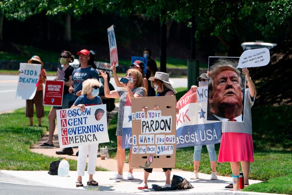 Protesters greet President Donald Trump as his motorcade leaves the Trump National Golf Club in Northern Virginia on July 11, 2020.