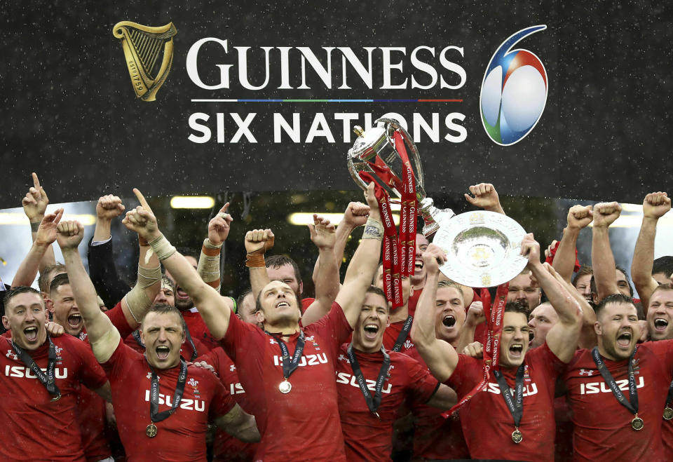 The Wales rugby team celebrates with their trophies after winning the Six Nations championships, following the international rugby union match between Wales and Ireland at the Millennium stadium in Cardiff, Wales, Saturday, March 16, 2019. Wales have won the Six Nations Championships after defeating Ireland in their final game. (David Davies/Pool Photo via AP)