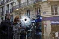 <p>A bullet hole seen on the window of a cafe located near the area where the assailant of a knife attack was shot dead by police officers, in central Paris, Sunday May 13, 2018. (Photo: Thibault Camus/AP) </p>