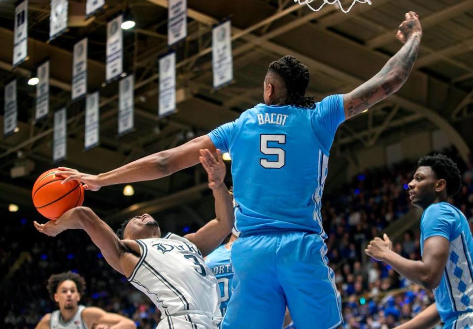 North Carolina’s Armando Bacot (5) blocks a shot by Duke’s Jeremy Roach (3) in the first half on Saturday, February 4, 2023 at Cameron Indoor Stadium in Durham, N.C.