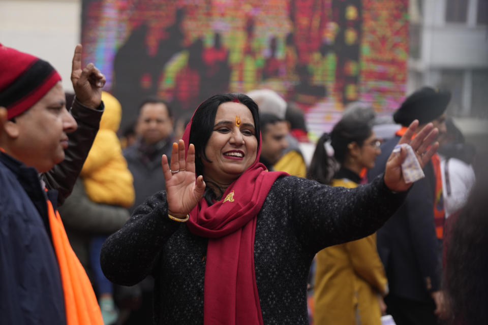 Hindu devotees dance at Raghutnath temple in Jammu, India, during the opening of a temple dedicated to Hindu deity Lord Ram, in Ayodhya, Monday, Jan.22, 2024. Indian Prime Minister Narendra Modi on Monday opened a controversial Hindu temple built on the ruins of a historic mosque in the holy city of Ayodhya in a grand event that is expected to galvanize Hindu voters in upcoming elections. (AP Photo/Channi Anand)
