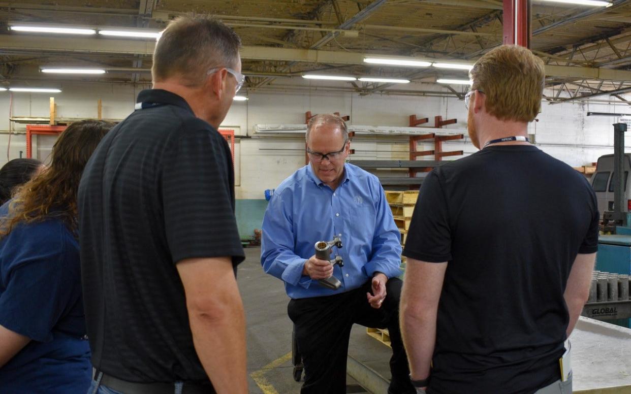 Dan Stott, president and owner of Port Clinton Manufacturing Company, discusses careers in manufacturing with teachers touring the school on June 9.