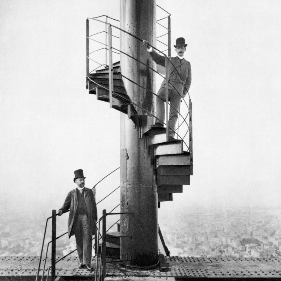 Gustave Eiffel (left) and a friend explore the newly built Eiffel Tower, 1889 - Bettmann