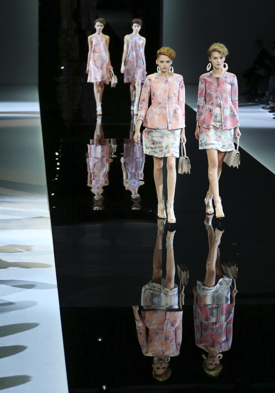 Models wear creations for Giorgio Armani's women's Spring-Summer 2014 collection, part of the Milan Fashion Week, unveiled in Milan, Italy, Monday, Sept. 23, 2013. (AP Photo/Antonio Calanni)