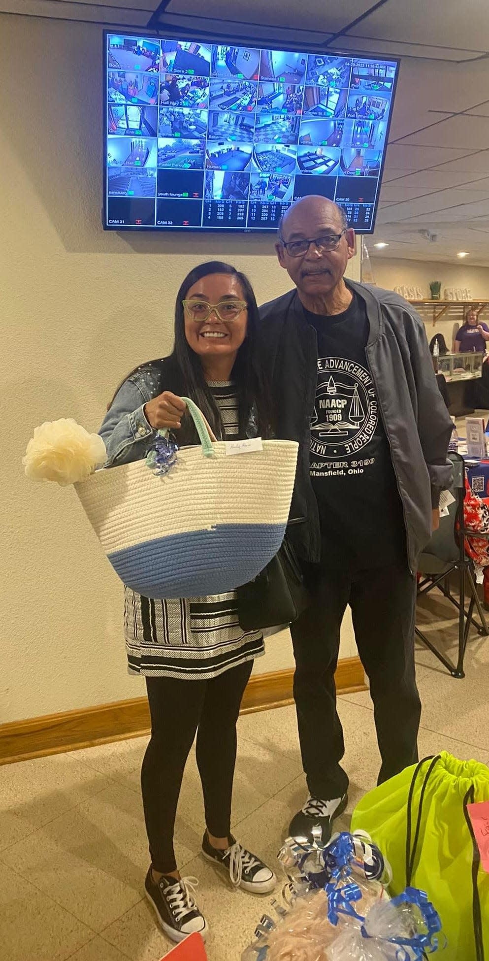 Mansfield NAACP President Leonard Dillon congratulates one of the raffle winners at the 2023 Minority Health Fair. The fair returns April 27.