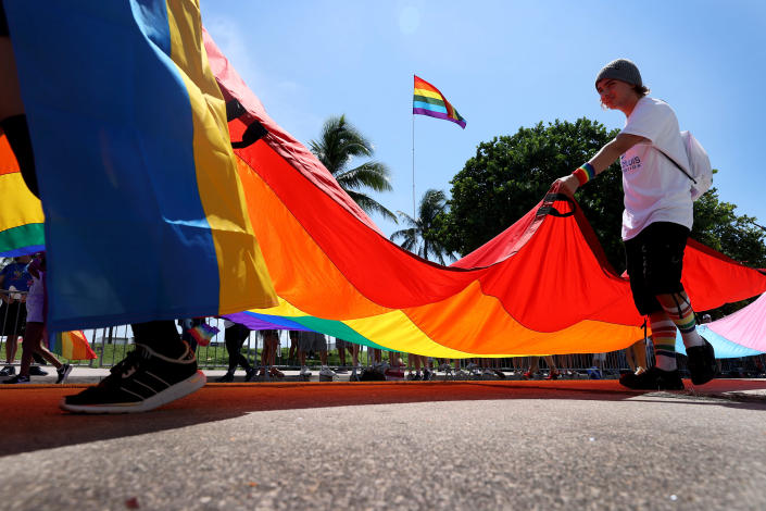 People carry the Rainbow Flag as they participate in the Miami Beach Pride Parade along Ocean Drive on September 19, 2021, in Miami Beach, Florida. <span class="copyright"> Joe Raedle/Getty Images</span>