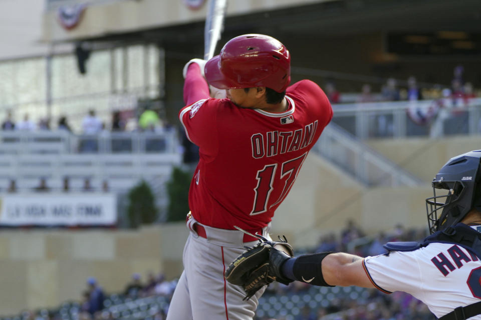 Los Angeles Angels' Shohei Ohtani hits a single off Minnesota Twins pitcher Dylan Bundy in the first inning of a baseball game, Sunday, Sept 25, 2022, in Minneapolis. (AP Photo/Jim Mone)