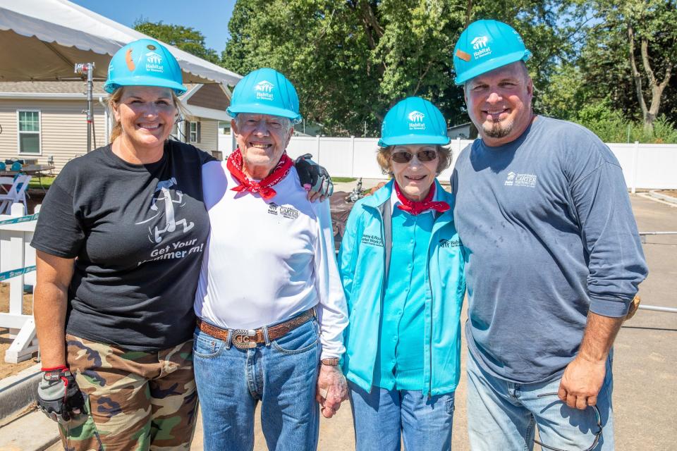 President Carter and Mrs. Carter (center) with Trisha Yearwood (left) and her husband, Garth Brooks (right), at the Habitat build in Mishawaka, Indiana, in 2018.