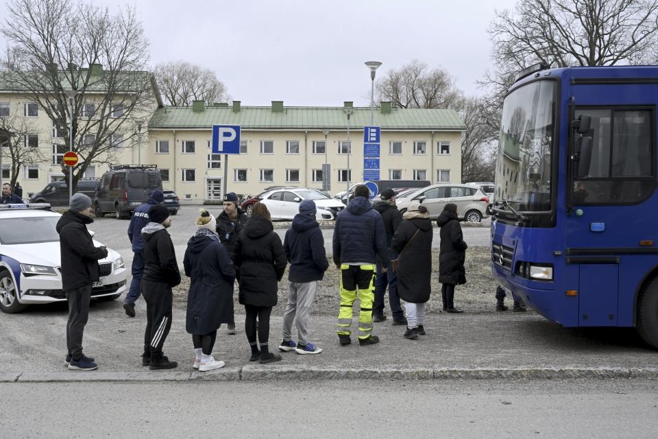 Police officers talk to family members of pupils at Viertola comprehensive school, in Vantaa, Finland, Tuesday, April 2, 2024. Finnish police say a number of people were wounded in a shooting at a school outside Helsinki and a suspect was detained. (Markku Ulander/Lehtikuva via AP)