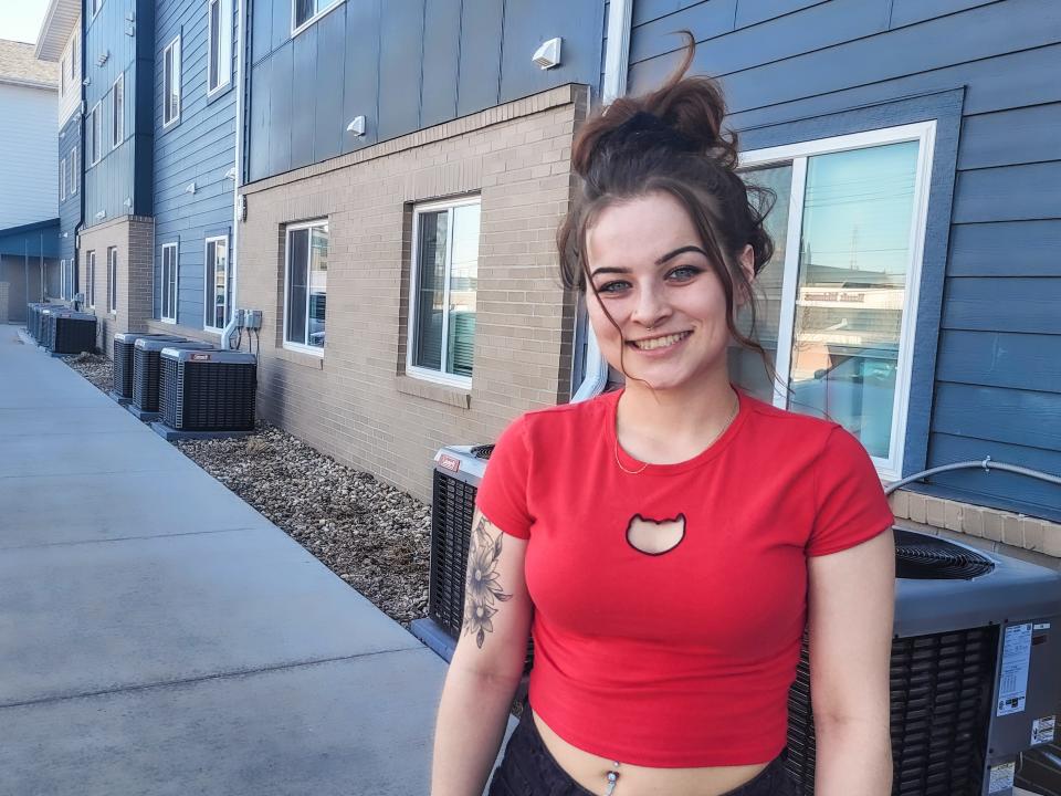 Jayden Delle poses for a photo outside her apartment on Wednesday, April 12. She lives at the Irving Center Apartments in downtown Sioux Falls.