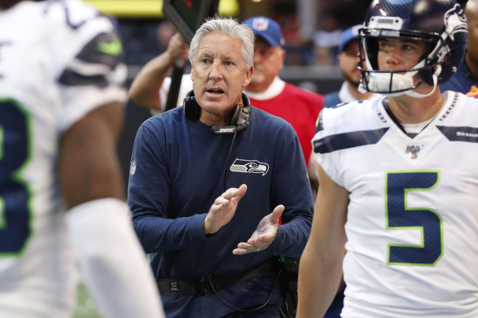 Seattle Seahawks head coach Pete Carroll speaks with players after a Seattle Seahawks field goal against the Atlanta Falcons during the first half of an NFL football game, Sunday, Oct. 27, 2019, in Atlanta. (AP Photo/John Bazemore)