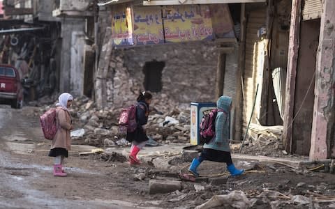 Children walk home from school in Mosul's Old City in Iraq, which was severely damaged in the fighting - Credit: Sam Tarling/Save the Children