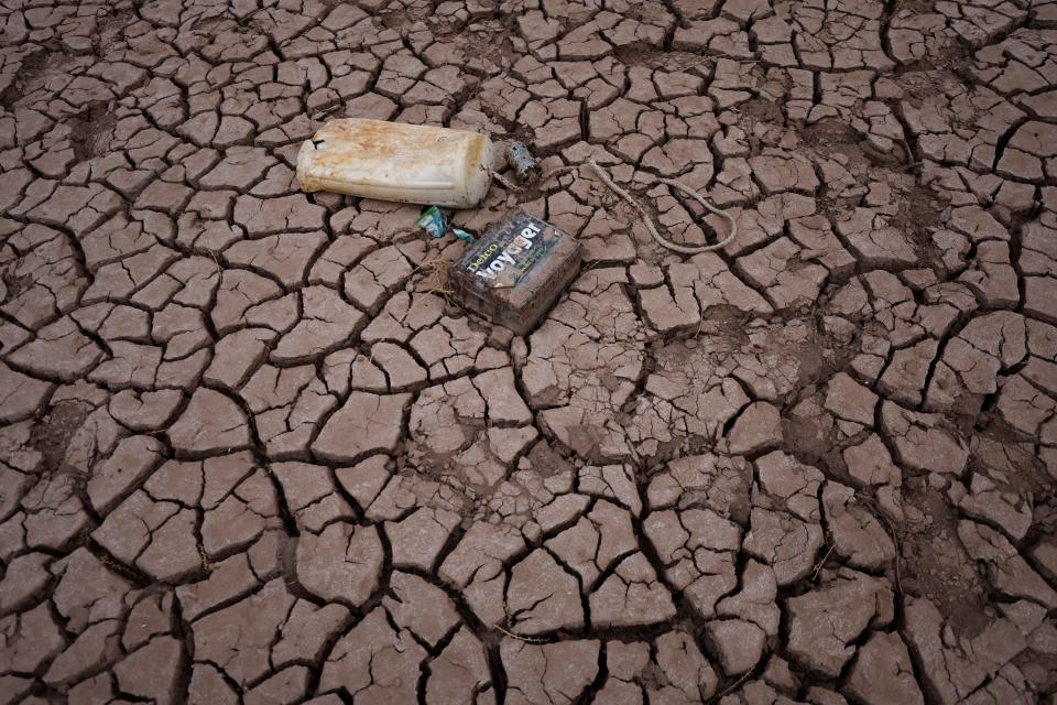 Dry cracked earth is visible in an area of Lake Powell that was previously underwater on March 28, 2022 in Page, Arizona. Lake Powell is currently at 25 percent of capacity, a historic low, and has also lost at least 7 percent of its total capacity. The Colorado River Basin connects Lake Powell and Lake Mead and supplies water to 40 million people in seven western states.