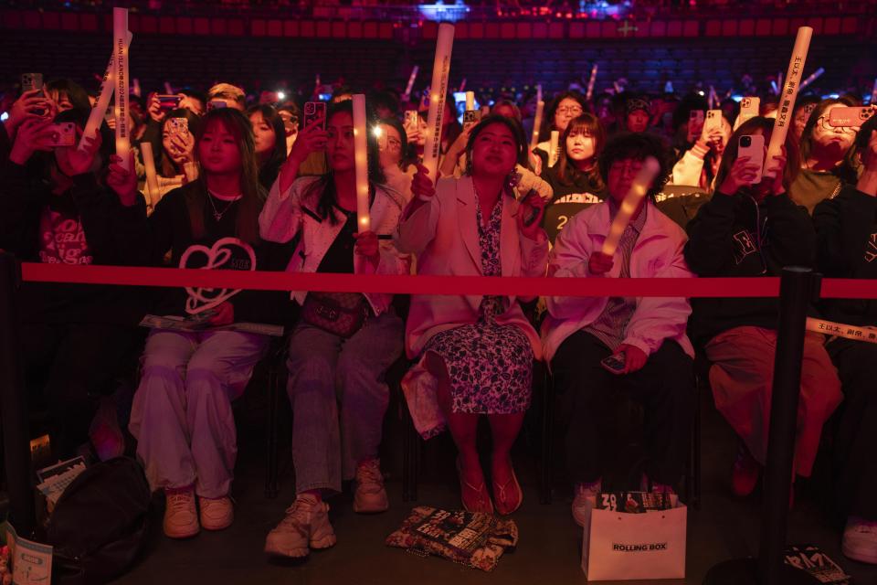 Fans of Chinese rappers including Boss X react during a performance in Chengdu in southwestern China's Sichuan province, Saturday, March 16, 2024. The rapper, who had come up from making music in a run-down apartment in an old residential community in the city, was now playing to a stadium of thousands. (AP Photo/Ng Han Guan)