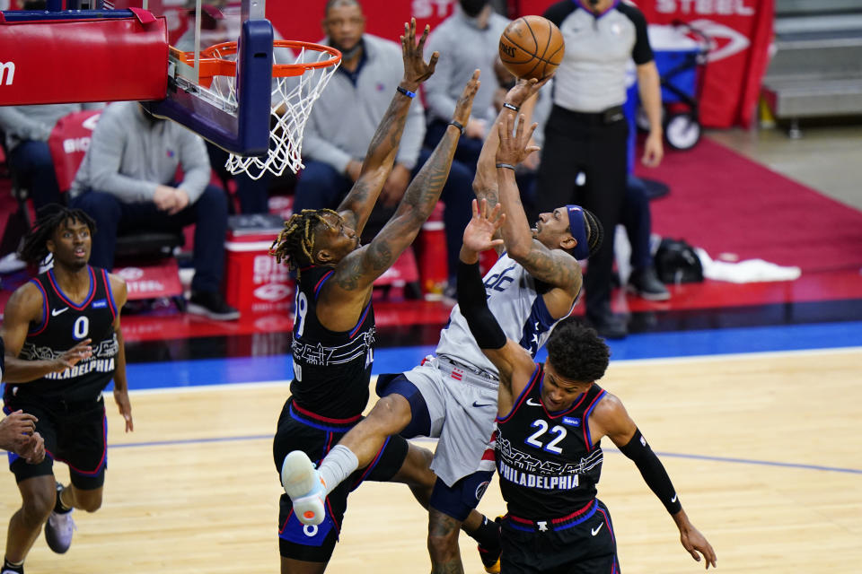 Washington Wizards' Bradley Beal center, tries to get a shot past Philadelphia 76ers' Matisse Thybulle, right, and Dwight Howard during the second half of Game 2 in a first-round NBA basketball playoff series, Wednesday, May 26, 2021, in Philadelphia. (AP Photo/Matt Slocum)