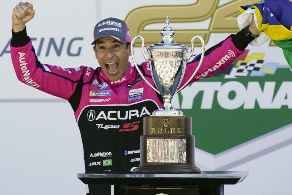 Helio Castroneves, of Brazil, celebrates in Victory Lane after winning the Rolex 24 hour auto race at Daytona International Speedway, Sunday, Jan. 30, 2022, in Daytona Beach, Fla. (AP Photo/John Raoux)