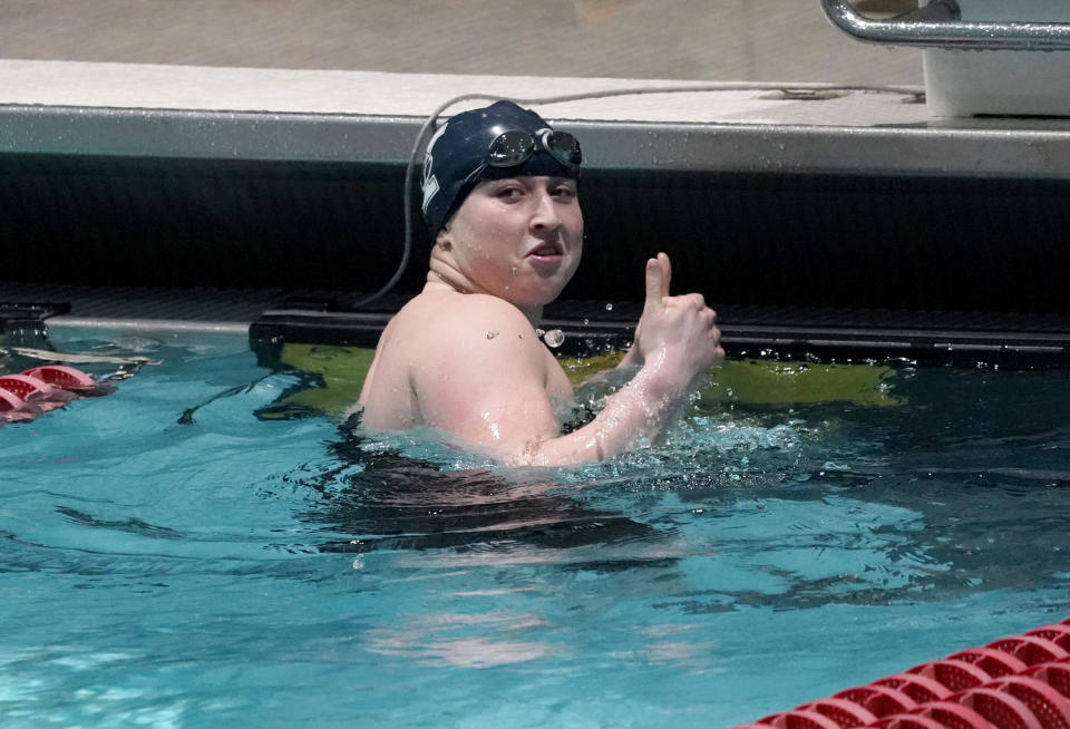 Yale's Iszac Henig gives two thumbs up after setting a pool record in a 50-yard freestyle qualifying event at the Ivy League Women's Swimming and Diving Championships at Harvard University, Thursday, Feb. 17, 2022, in Cambridge, Mass. Henig, who is transitioning to male but hasn't begun hormone treatments yet, is swimming for Yale's women's team. (AP Photo/Mary Schwalm)