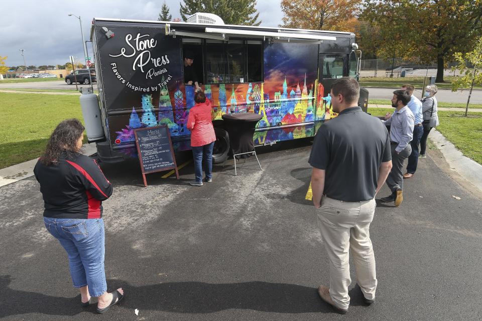 Customers wait for their orders from Stone Press Food Truck on Sept. 30, 2020, at Forward Bank in Marshfield.