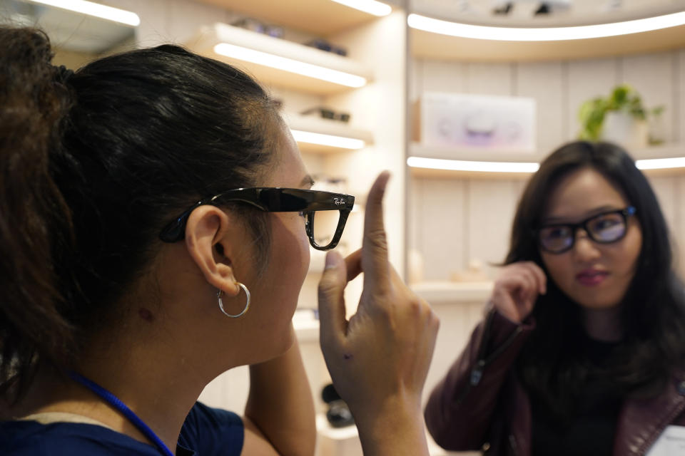 A Meta experience expert, left, demonstrates the Ray-Ban Stories smart glasses during a preview of the Meta Store in Burlingame, Calif., Wednesday, May 4, 2022. (AP Photo/Eric Risberg)