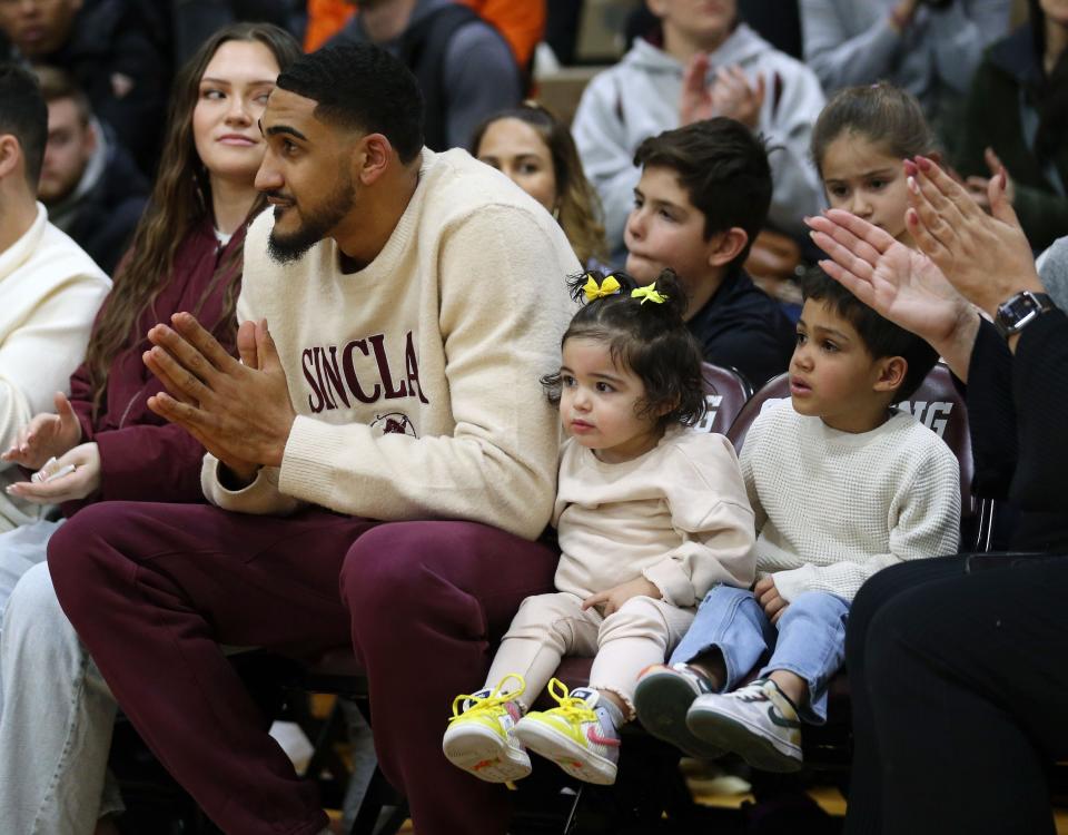 New York Knicks star, and former Ossining High School basketball player Obi Toppin sits with his family, during a ceremony retiring his number in the Ossining High School gym Feb. 3, 2023. 