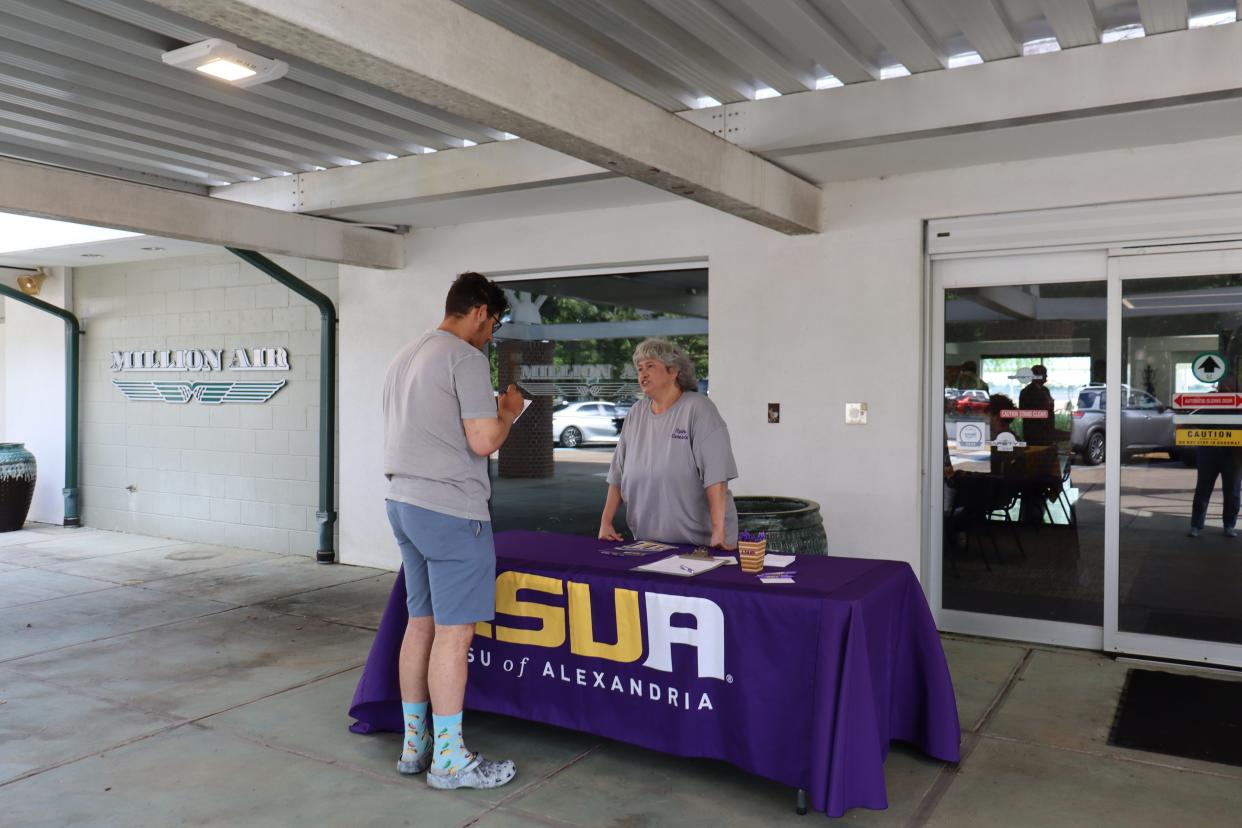 Louisiana State University of Alexandria professional aviation student Mattilla Wiley greeted people coming to an open house Thursday at Million Air at England Airpark. Wiley, 52, is working toward a degree in aviation managment.