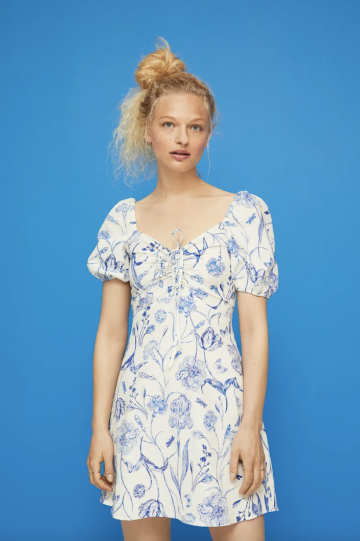 blonde model on blue background wearing white and blue Linen-Blend Dress (Photo via H&M)