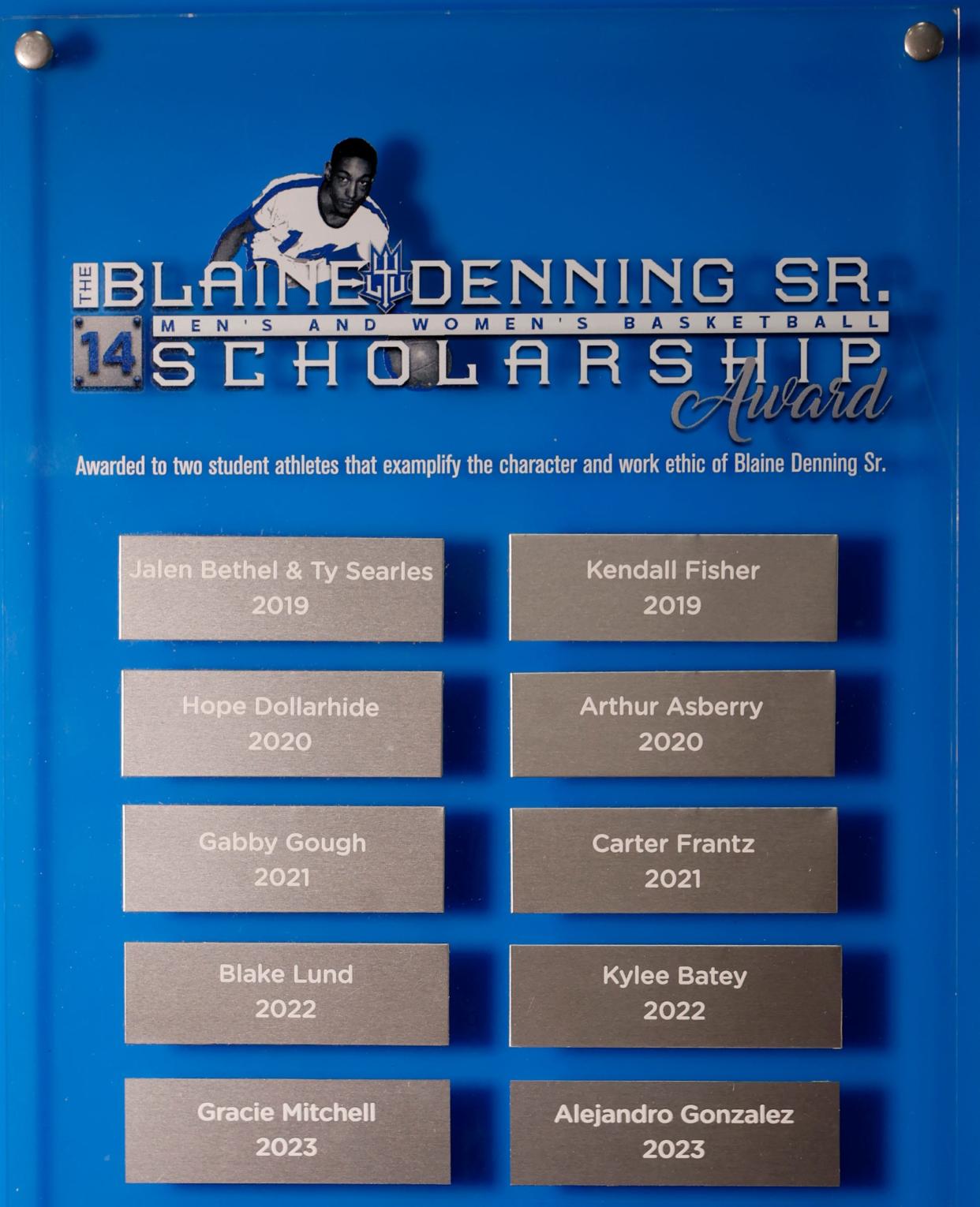 A plaque honoring the several winners of the Blaine Denning Sr. Men's and Women's Basketball Scholarship Award that is on a wall inside the Don Ridler Field House on Wednesday, Feb. 21, 2024.