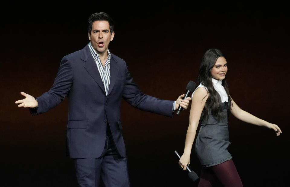 Eli Roth, left, writer/director of the upcoming film "Borderlands," and cast member Ariana Greenblatt walk onstage for the Lionsgate presentation at CinemaCon 2024, Wednesday, April 10, 2024, at Caesars Palace in Las Vegas. (AP Photo/Chris Pizzello)