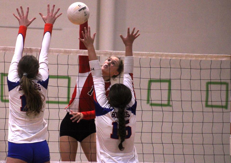 Bishop Kenny's Claudia Stockard (14) leaps for a spike against Bolles' Edel Kibbe and Gracie Arnett during  a high school volleyball match on September 8, 2022. [Clayton Freeman/Florida Times-Union]