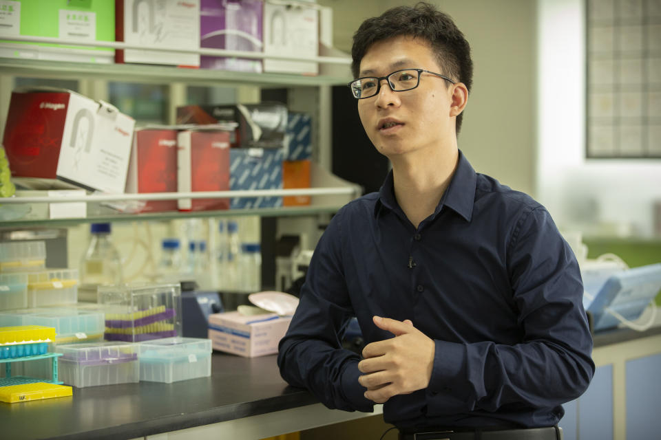 In this Oct. 9, 2018, photo, Chinese scientist Qin Jinzhou speaks during an interview with the Associated Press in a laboratory in Shenzhen in southern China's Guangdong Province. Three researchers involved in the births of genetically edited babies have been convicted and sentenced for practicing medicine illegally, Chinese state media said Monday. Qin received an 18-month sentence, but with a two-year reprieve, and a 500,000 yuan fine. (AP Photo/Mark Schiefelbein)