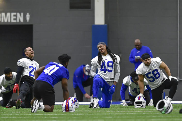 Buffalo Bills linebacker Tremaine Edmunds (49) shares a laugh with safety Jordan Poyer (21), fullback Reggie Gilliam (41) and linebacker Matt Milano (58) as the warm up during an NFL football practice in Orchard Park, N.Y., Friday, Jan. 13, 2023. (AP Photo/Adrian Kraus)