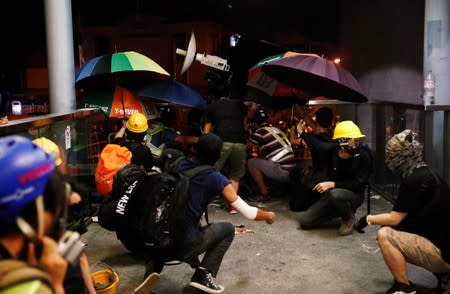 Demonstrators march to protest against the Yuen Long attacks in Yuen Long