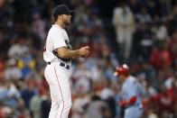 Boston Red Sox's Kutter Crawford, left, looks to the outfield after giving up a solo home run to St. Louis Cardinals' Nolan Gorman, back right, during the fourth inning of a baseball game, Saturday, June 18, 2022, in Boston. (AP Photo/Michael Dwyer)