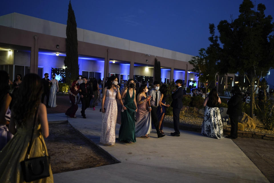 Young people attend prom at the Grace Gardens Event Center in El Paso, Texas on Friday, May 7, 2021. Around 2,000 attended the outdoor event at the private venue after local school districts announced they would not host proms this year. Tickets cost $45. (AP Photo/Paul Ratje)