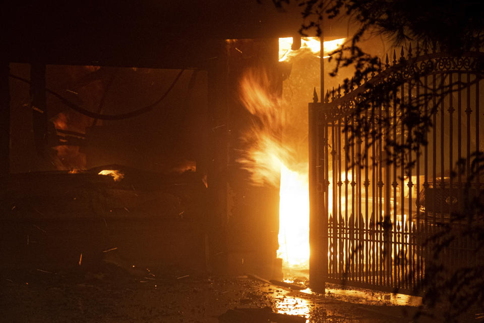 Flames shoot out from the front of a house on Jolette Way in Granada Hills North, Calif., early Friday morning, Oct. 11, 2019. (Photo: David Crane/The Orange County Register via AP)